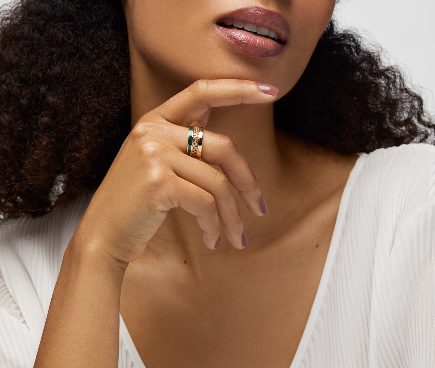 A woman wearing a Birks Dare to Dream malachite ring.